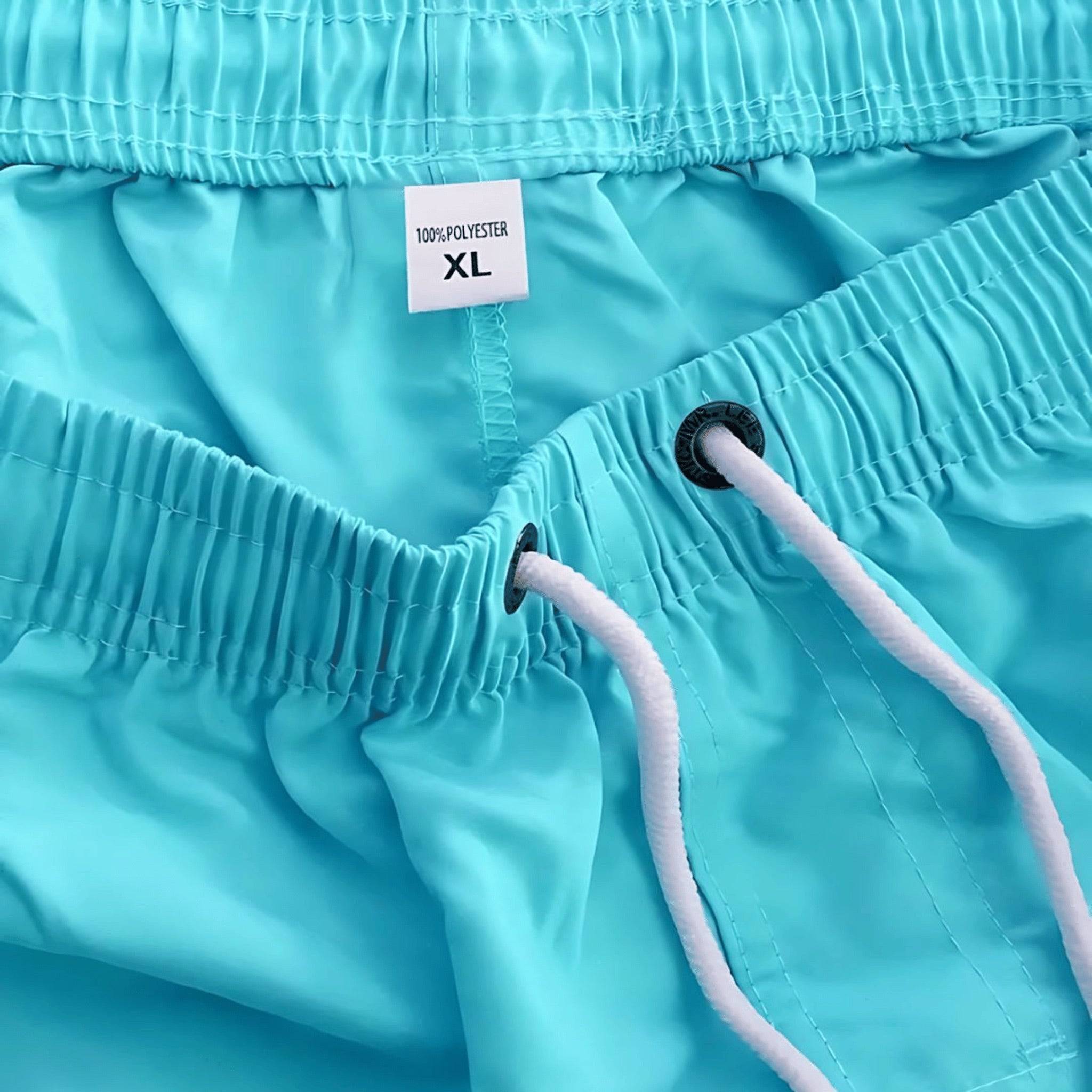 Interior view of Classic Short Shorts in aqua blue, highlighting elastic waistband, drawstring, and size tag for XL fit.