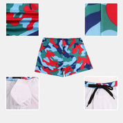 Close-up details of Commando Cut Swim Trunks in red-blue camo, showing drawstring, stitching, inner modesty pad, and back view design.