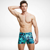 Green camouflage Commando Cut Swim Trunks featuring a tailored square-cut silhouette and adjustable drawstring for secure swimwear fit.