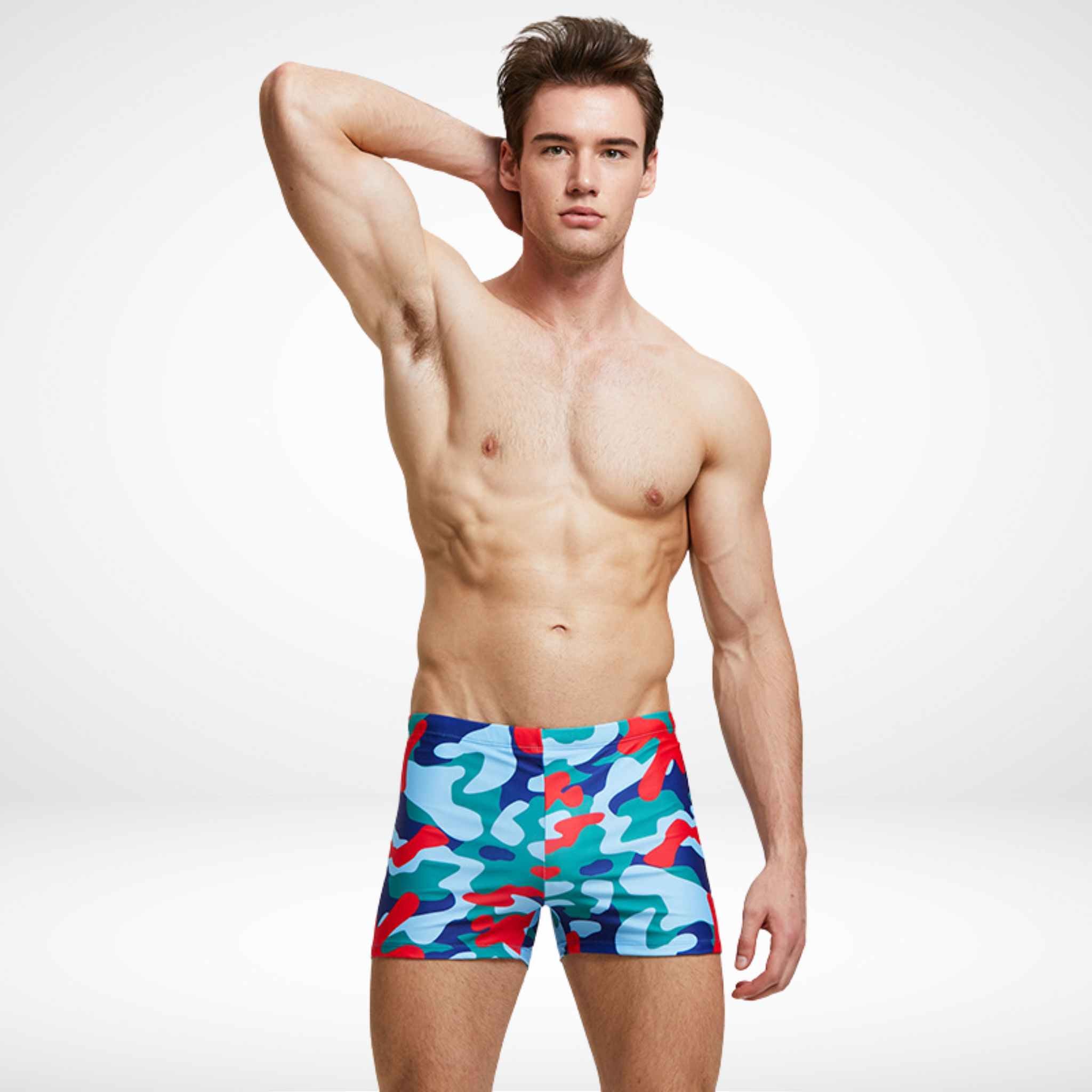 Red and blue camouflage Commando Cut Swim Trunks with quick-dry fabric and drawstring waist, designed for bold swimwear performance.