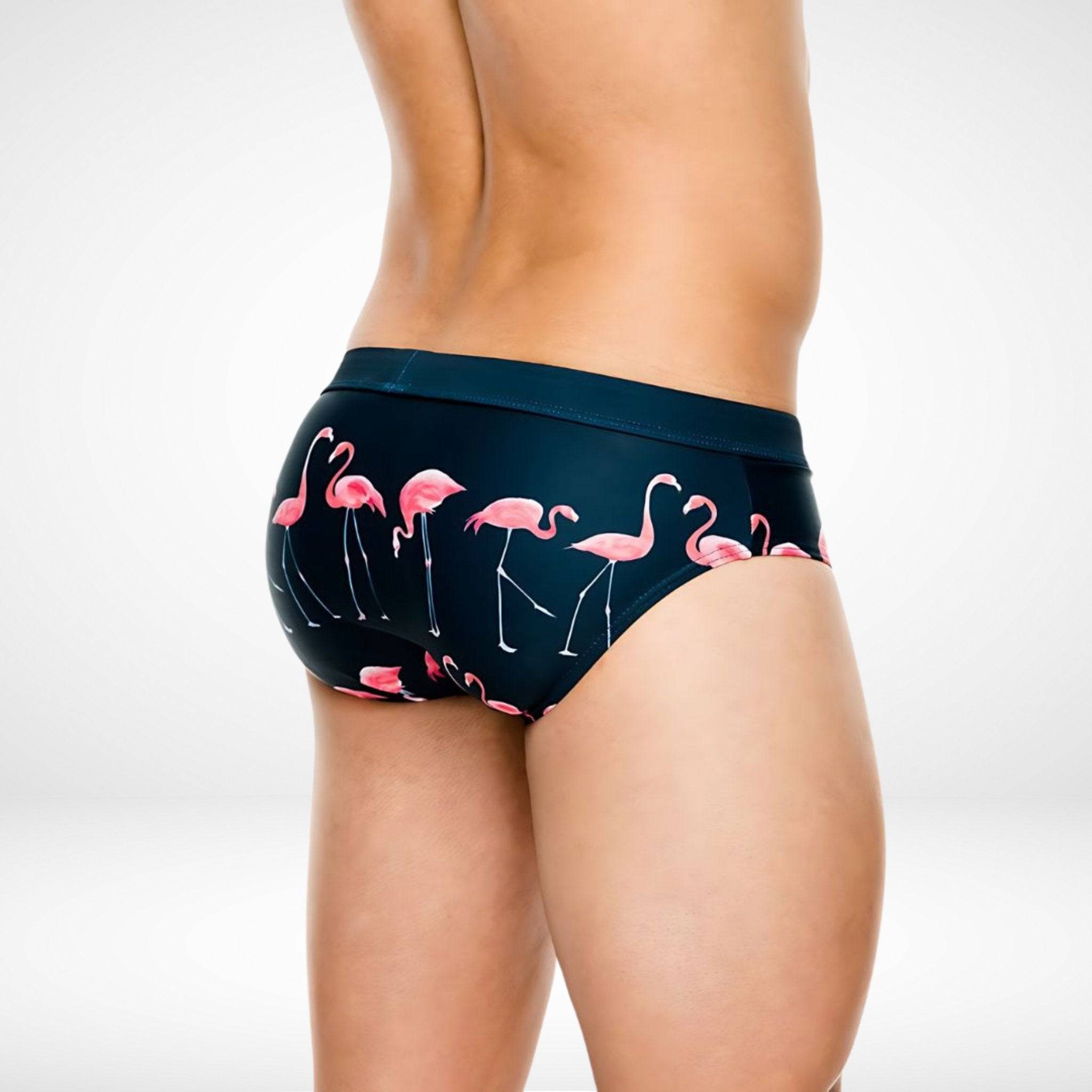 Back view of Flamingo Print Swim Briefs – Fun, Quick-Dry Men's Swimwear featuring vibrant pink flamingos on dark fabric for stylish swimwear appeal.