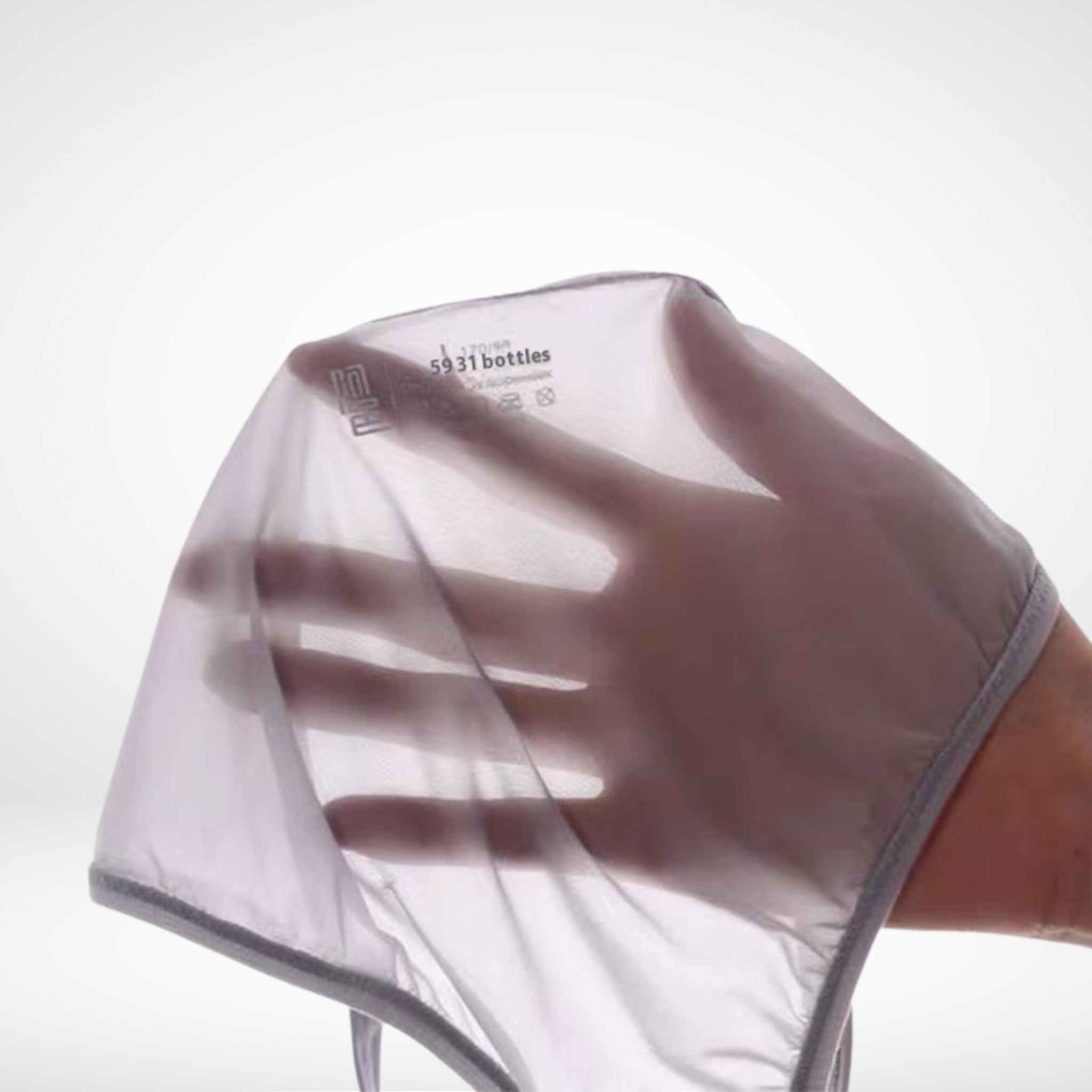 Hand holding white sheer ice silk briefs to show ultra-thin mesh fabric. See-through men's underwear made from recycled materials.