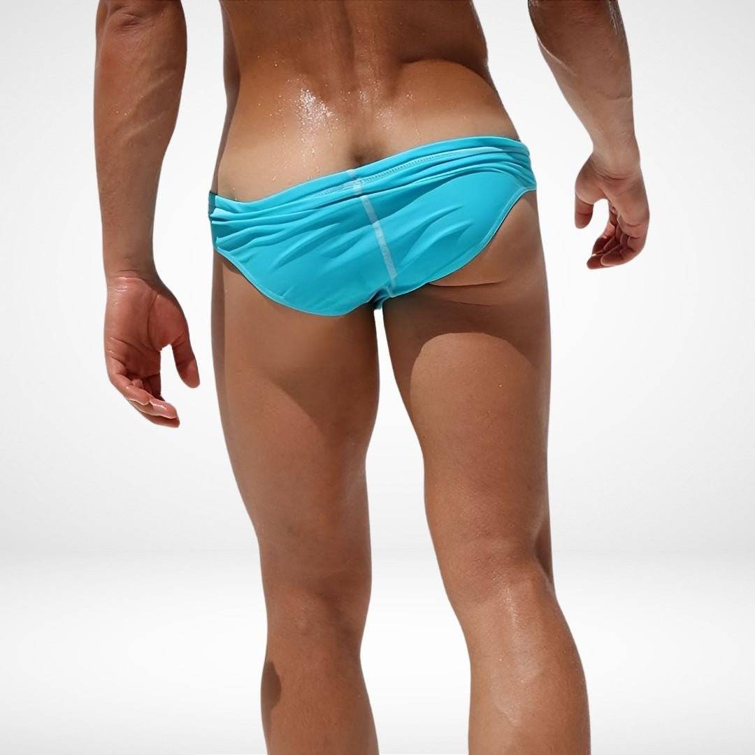 Back view of men's side eyelet swim briefs in aqua blue, showcasing snug fit and quick-dry fabric for beach or pool wear.