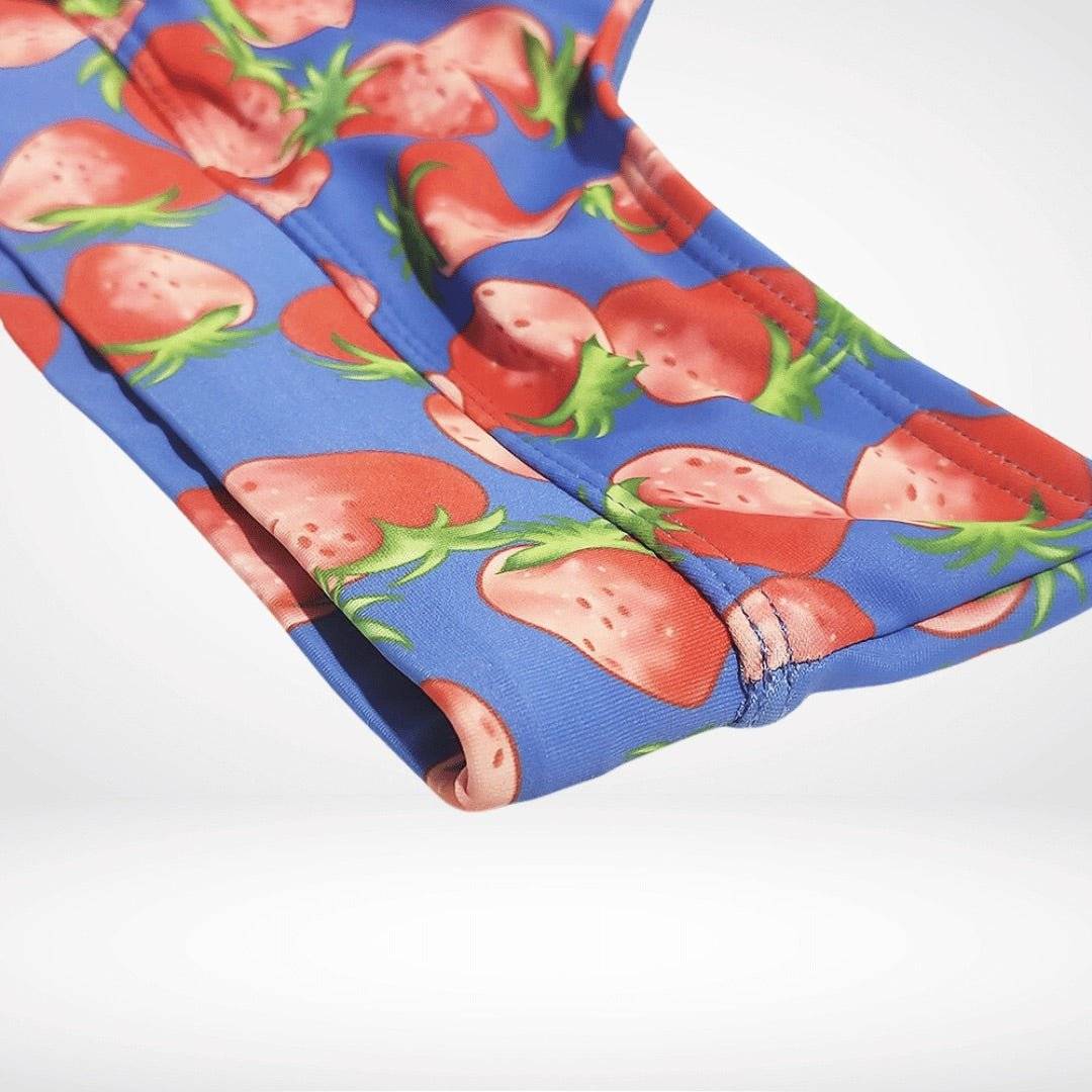 Fabric close-up of Strawberry Print Swim Briefs – Fun, Quick-Dry Men's Swimwear highlighting smooth texture and colorful strawberry print on blue.