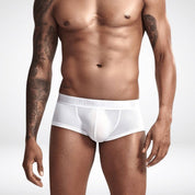 White transparent ice silk boxer briefs worn by male model. Lightweight, sheer men's underwear with a smooth, supportive fit.