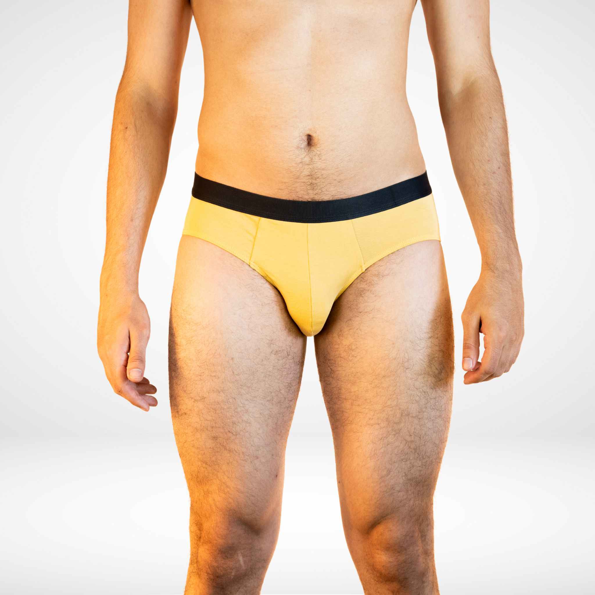 Front view of Soft Modal Comfort Fit Men's Briefs in mustard yellow, featuring soft fabric and flexible waistband.