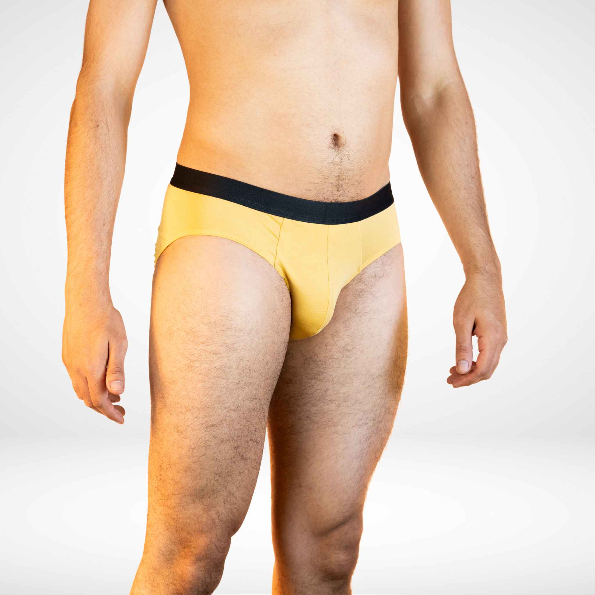 Side view of Soft Modal Comfort Fit Men's Briefs in mustard yellow, designed for breathable and stretchable comfort.
