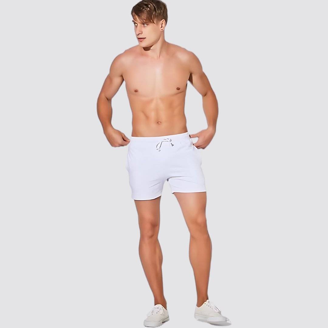 UrbanFit Basics Everyday Shorts in white, modeled shirtless, offering a crisp look with breathable stretch fabric for daily wear.