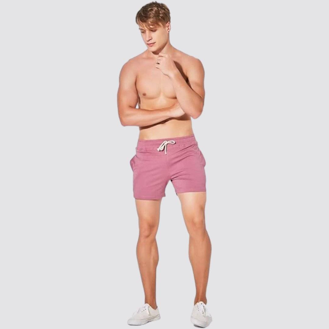 UrbanFit Basics Everyday Shorts in dusty rose, modeled shirtless, offering a stylish and comfortable fit for everyday wear.