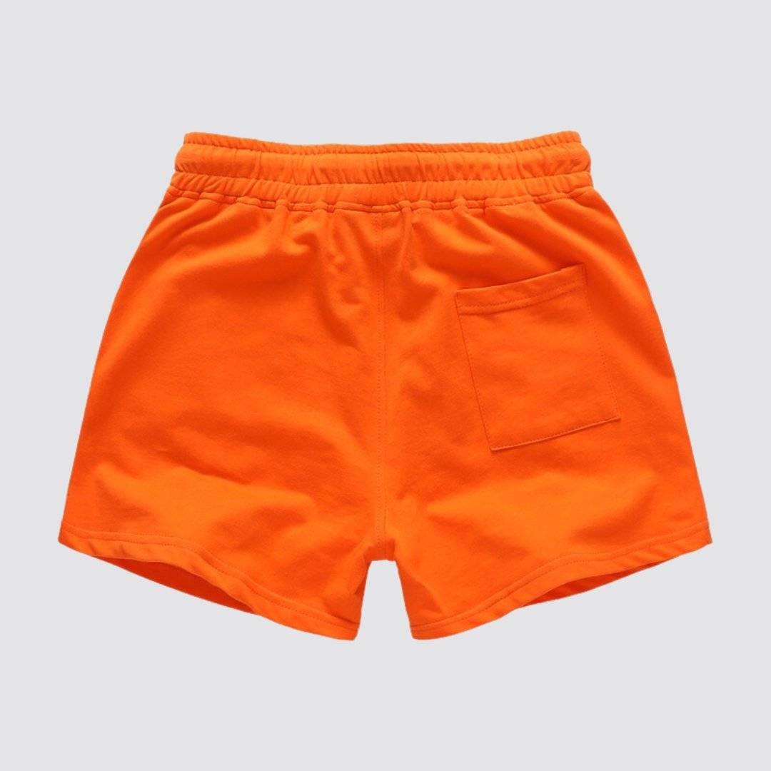 Back view of UrbanFit Basics Everyday Shorts in orange, highlighting the single back pocket and elastic waistband.