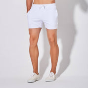 Front view of UrbanFit Basics Everyday Shorts in white, showcasing a clean, minimalist design with drawstring and side pockets.
