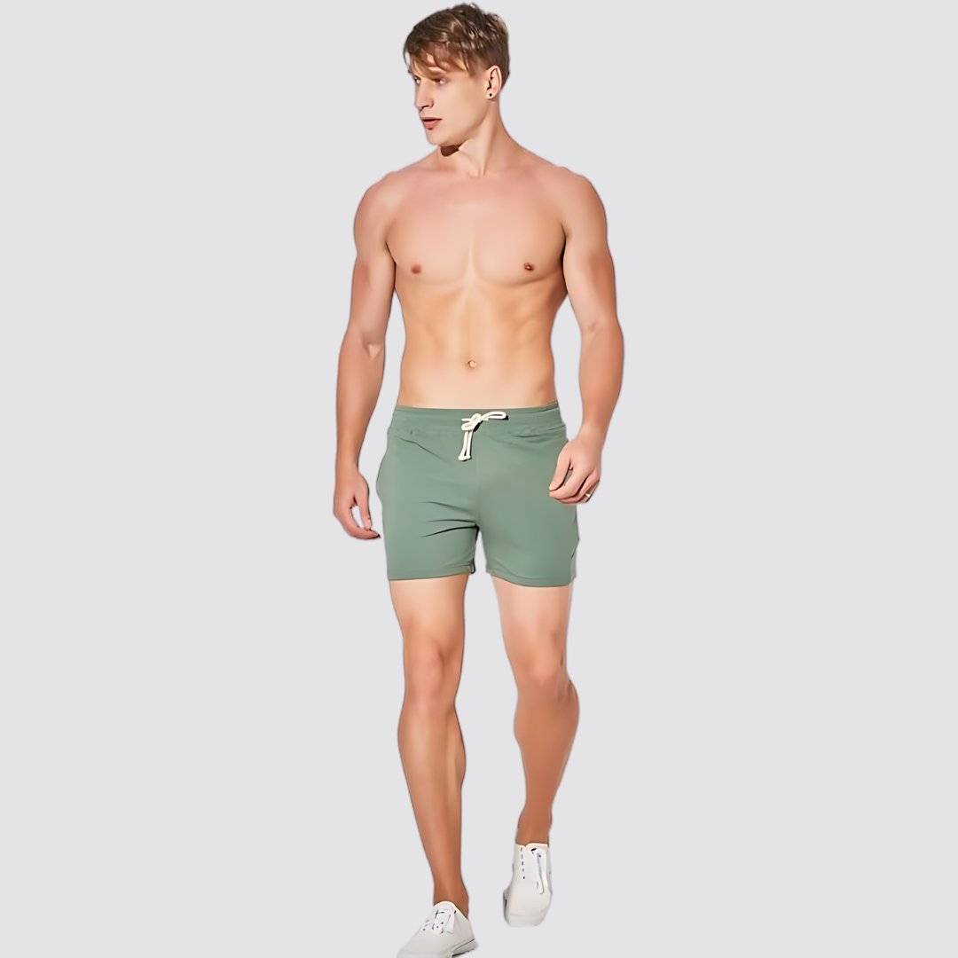 UrbanFit Basics Everyday Shorts in olive green, modeled shirtless, offering a relaxed fit and breathable cotton blend for casual wear.