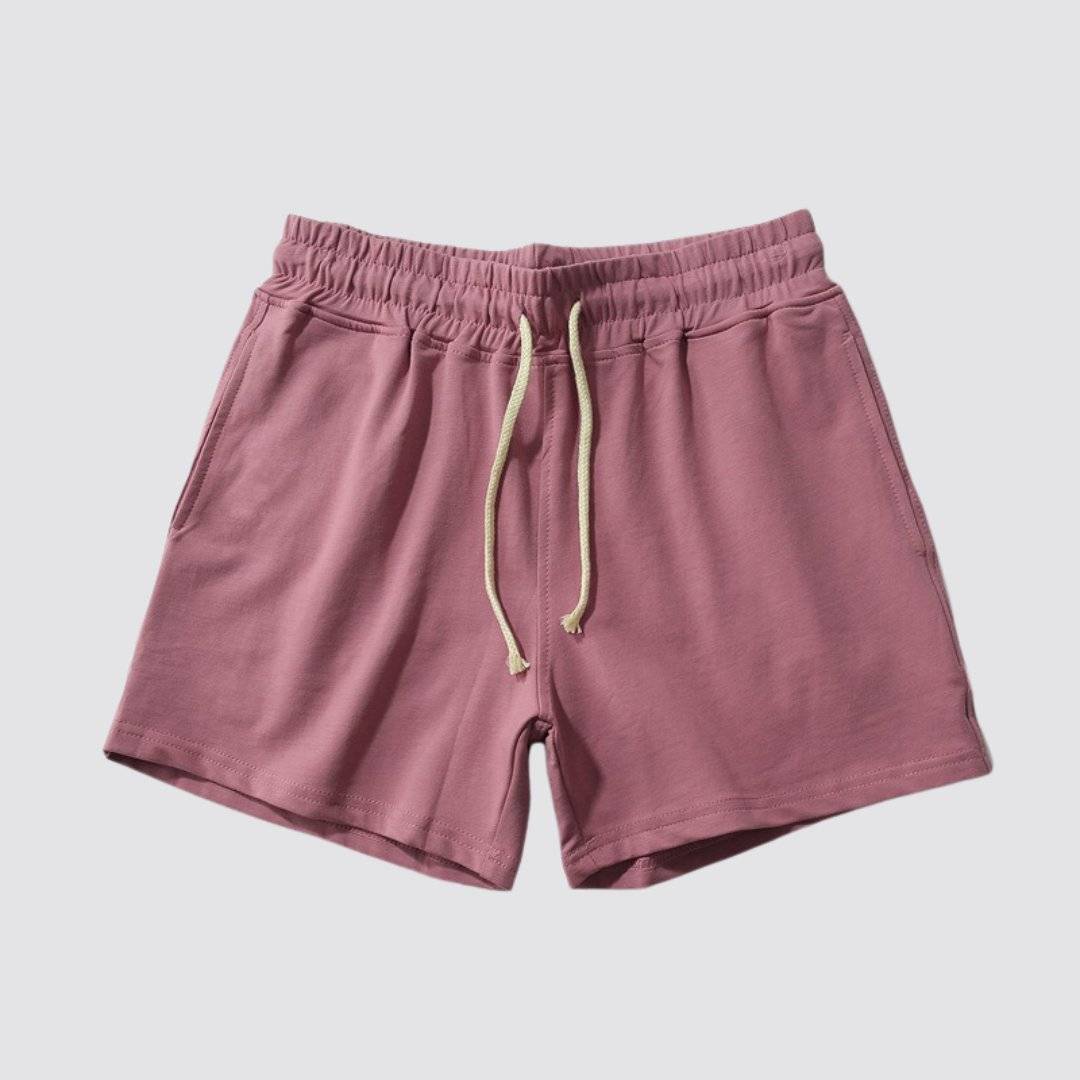 Flat lay of UrbanFit Basics Everyday Shorts in dusty rose, with elastic waistband and dual pockets for casual versatility.