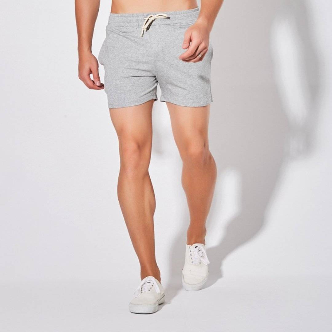 Front view of UrbanFit Basics Everyday Shorts in light grey, designed with a slim fit, elastic waistband, and side pockets.