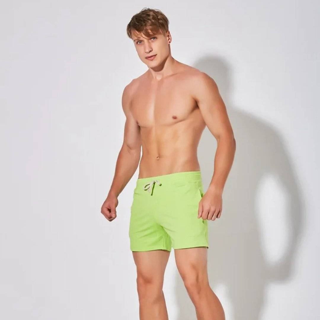 UrbanFit Basics Everyday Shorts in neon green, modeled shirtless, ideal for bold casual style and breathable comfort.