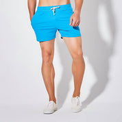 Close-up of UrbanFit Basics Everyday Shorts in blue, highlighting the slim fit, elastic waistband, and breathable stretch fabric.