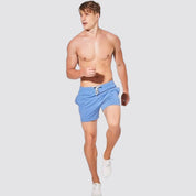 UrbanFit Basics Everyday Shorts in sky blue, modeled shirtless, perfect for active or casual wear with stretch comfort.