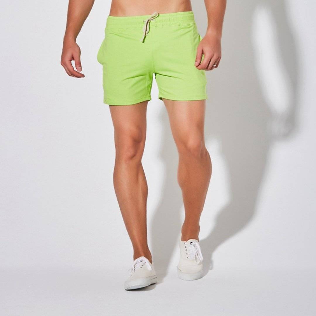 Front view of UrbanFit Basics Everyday Shorts in neon green, featuring stretch fabric and drawstring waist for active comfort.