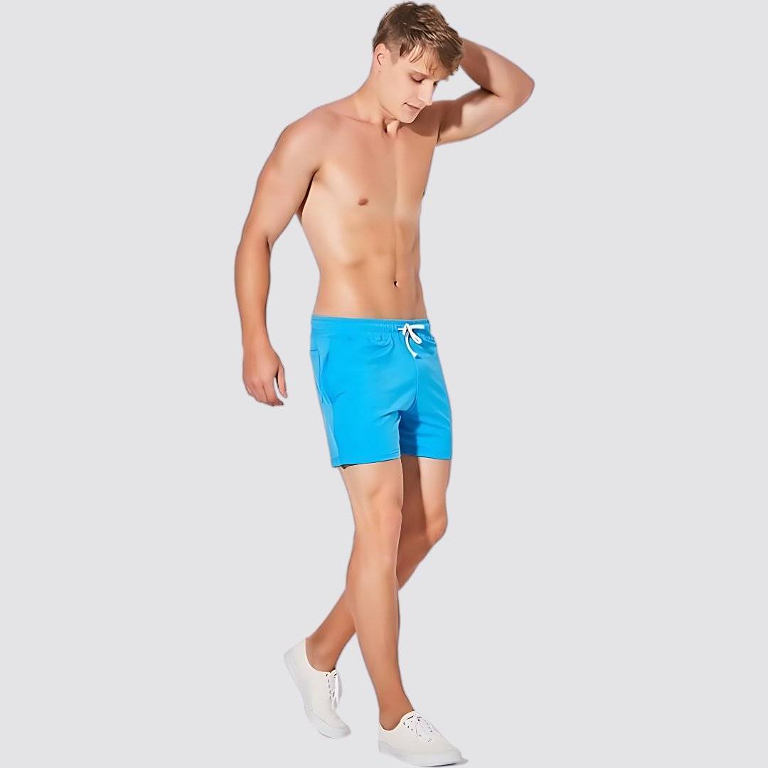 Men's UrbanFit Basics Everyday Shorts in blue shown in motion, designed for flexibility and everyday wear with a modern athletic fit.