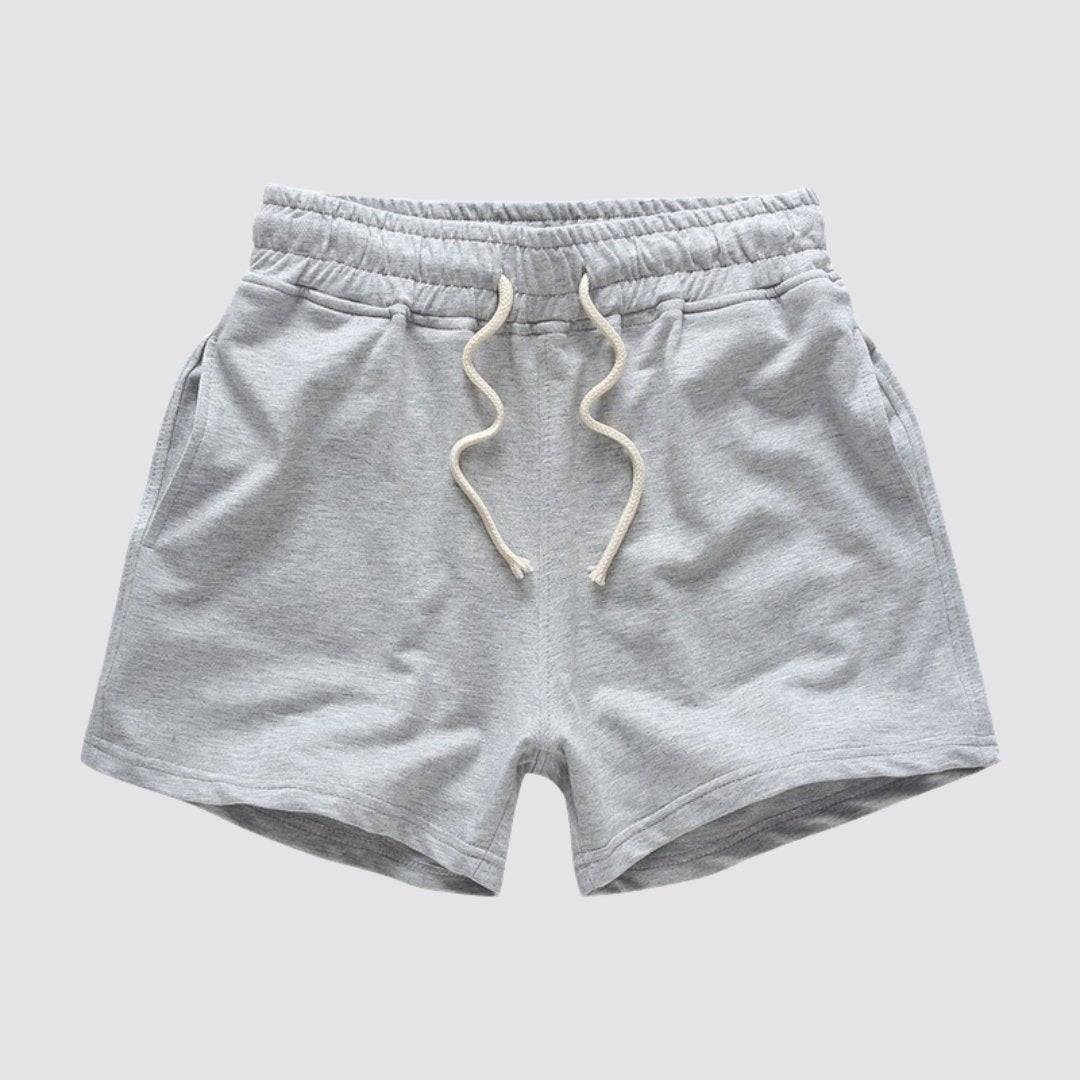 Flat lay of UrbanFit Basics Everyday Shorts in light grey, made from no-fade cotton blend with drawstring and side pockets.