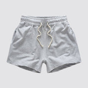 Flat lay of UrbanFit Basics Everyday Shorts in light grey, made from no-fade cotton blend with drawstring and side pockets.