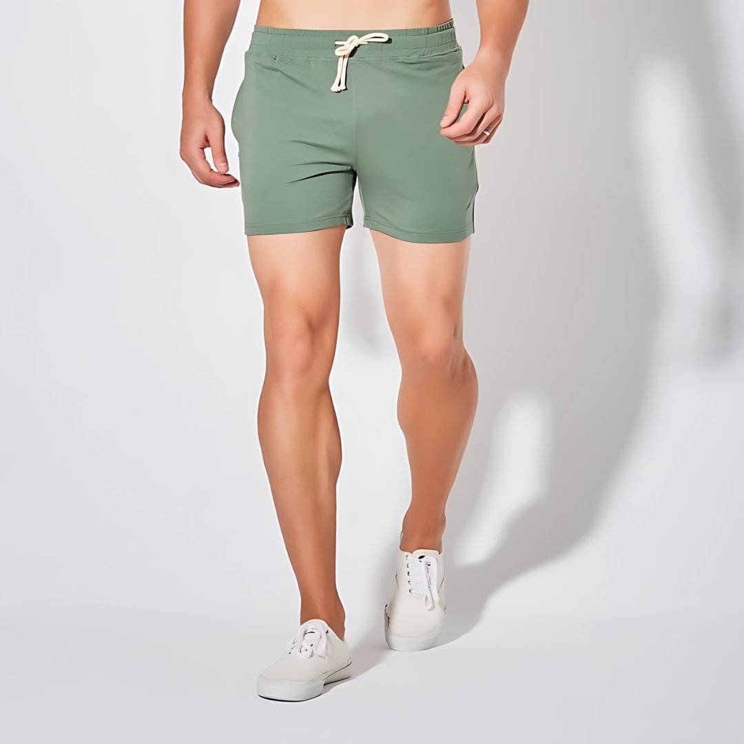UrbanFit Basics Everyday Shorts in olive green, shown in close-up with drawstring and side pockets for casual versatility.