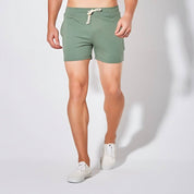 UrbanFit Basics Everyday Shorts in olive green, shown in close-up with drawstring and side pockets for casual versatility.