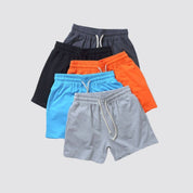 UrbanFit Basics Everyday Shorts multipack in five colors—black, charcoal, orange, blue, and grey—made from stretch cotton for versatile casual wear.
