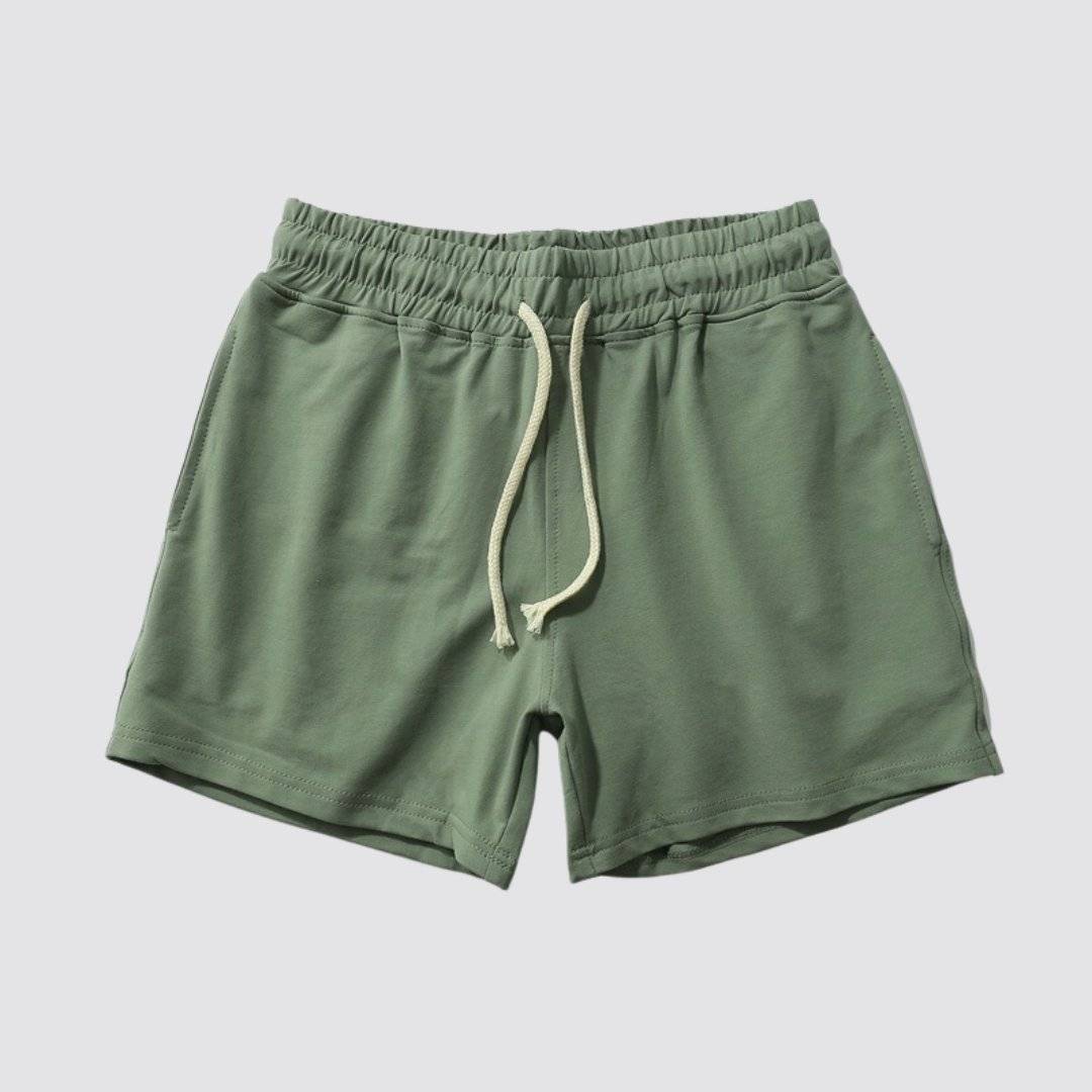 Flat lay of UrbanFit Basics Everyday Shorts in olive green, made with stretch cotton and adjustable waistband for daily wear.