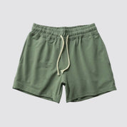 Flat lay of UrbanFit Basics Everyday Shorts in olive green, made with stretch cotton and adjustable waistband for daily wear.