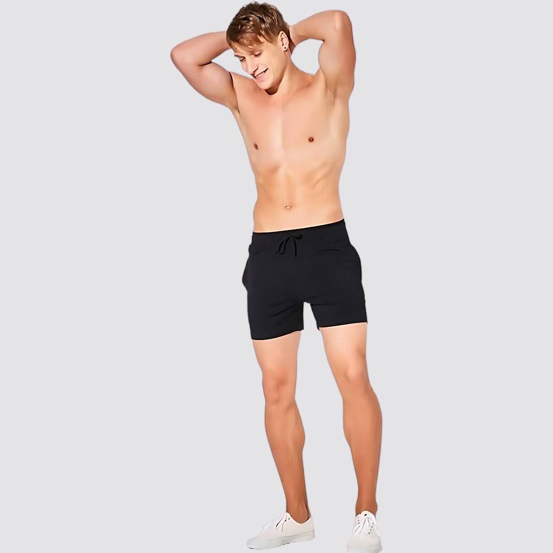 UrbanFit Basics Everyday Shorts in black modeled shirtless, showcasing the snug fit and minimalist design for daily comfort.