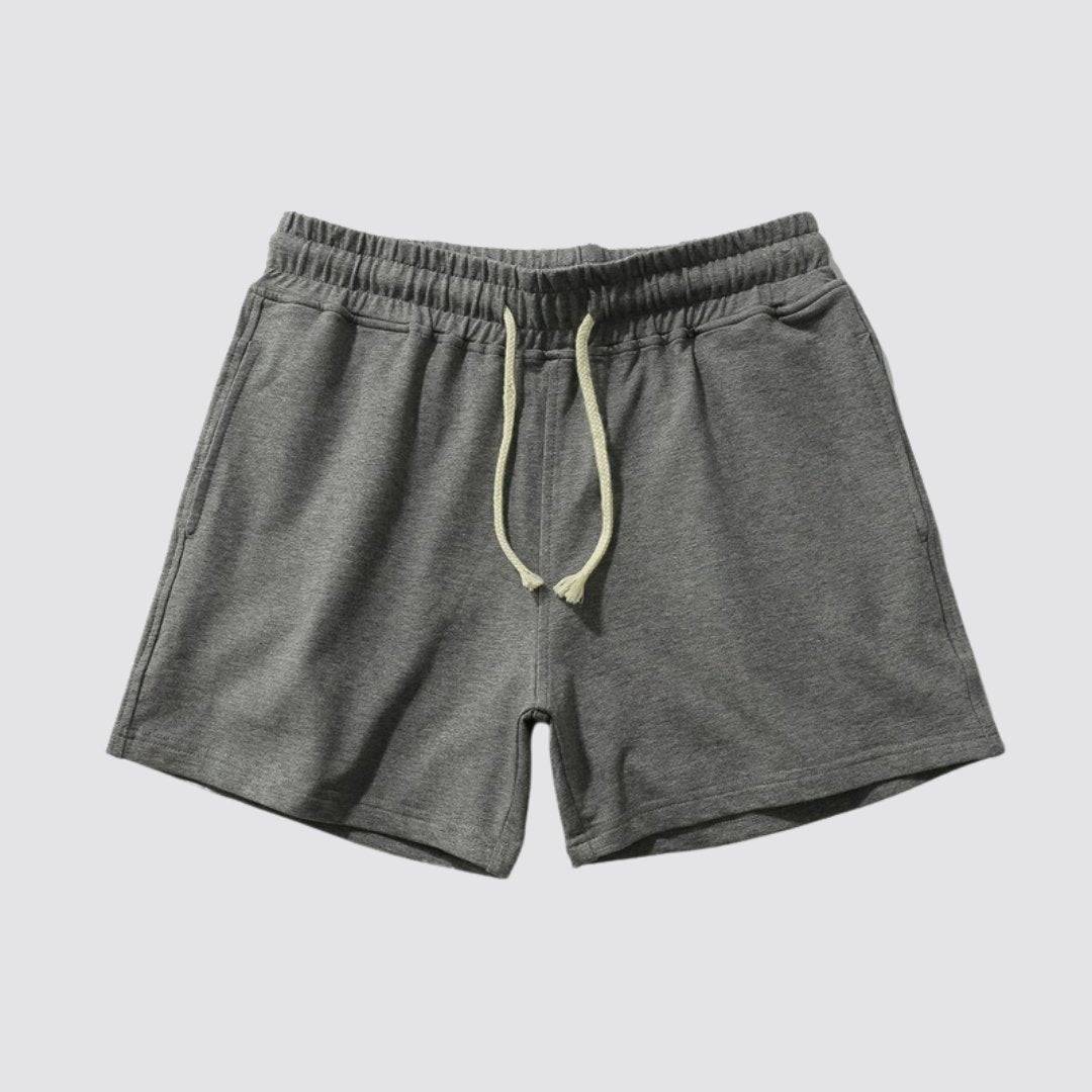 Flat lay of UrbanFit Basics Everyday Shorts in charcoal grey, designed with soft cotton blend and side pockets for comfort.