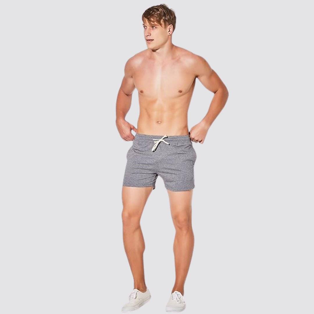 UrbanFit Basics Everyday Shorts in dark heather grey, modeled shirtless, showcasing a fitted cut and casual style.