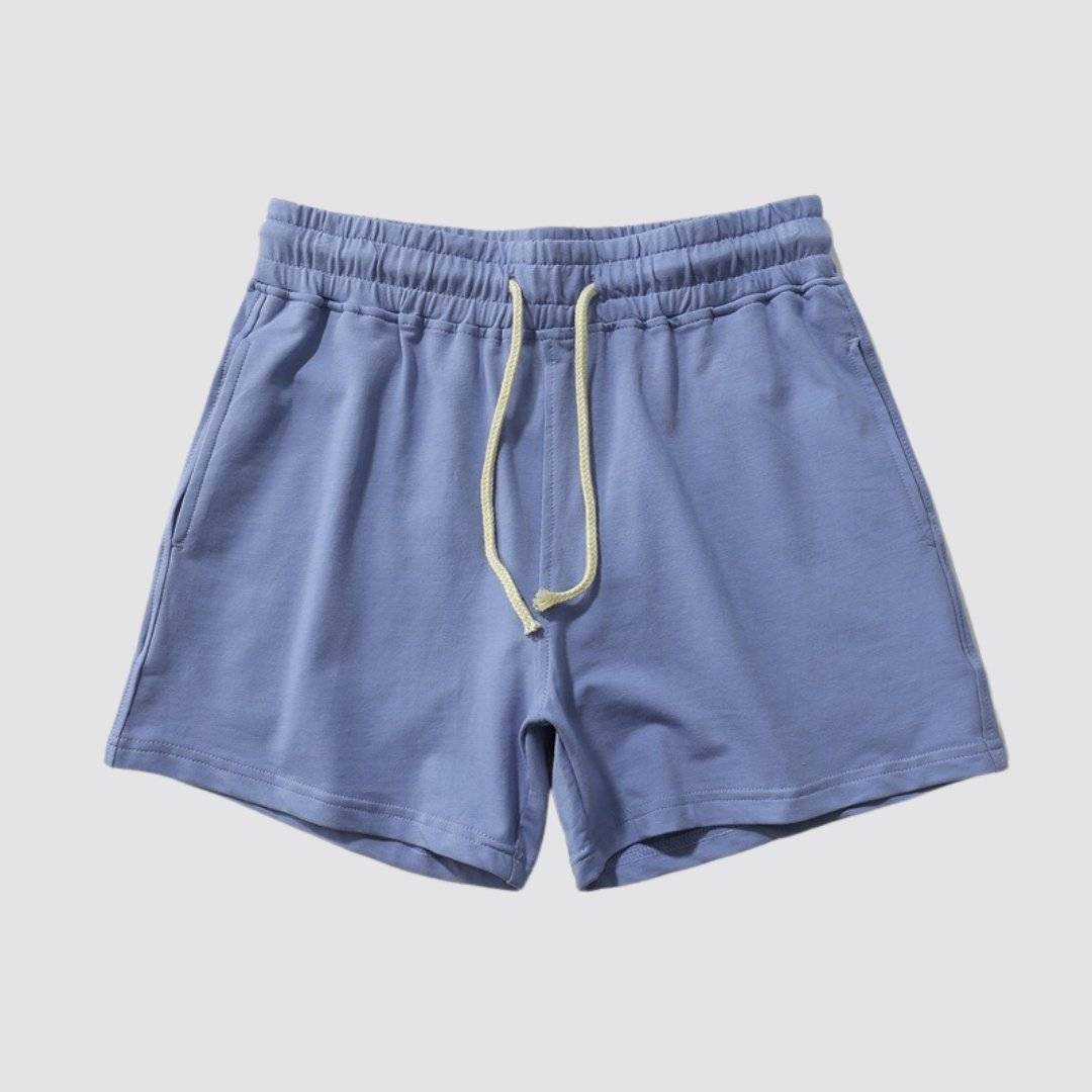 Flat lay of UrbanFit Basics Everyday Shorts in sky blue, made from stretch cotton blend with no-fade fabric and side pockets.