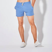 Front view of UrbanFit Basics Everyday Shorts in sky blue, featuring side pockets and drawstring waist for adjustable comfort.