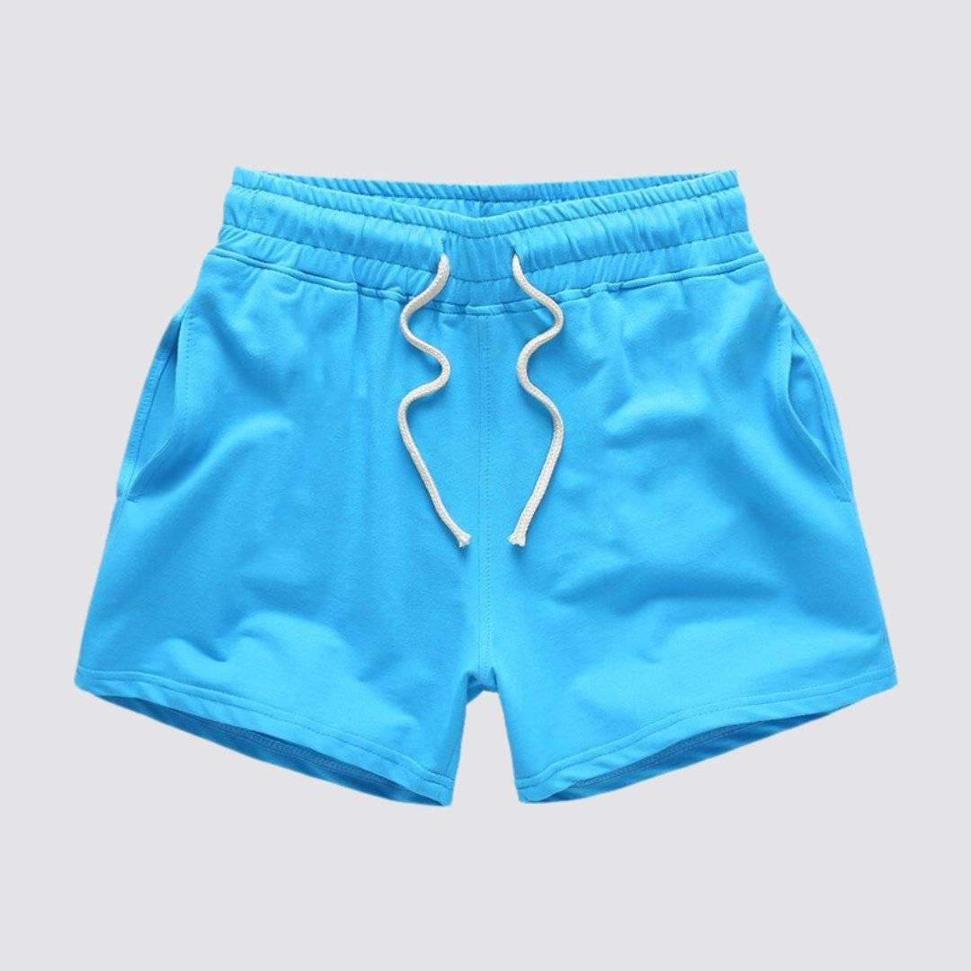 Flat lay of UrbanFit Basics Everyday Shorts in blue with drawstring closure and dual side pockets, ideal for casual and active use.