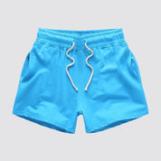 Flat lay of UrbanFit Basics Everyday Shorts in blue with drawstring closure and dual side pockets, ideal for casual and active use.