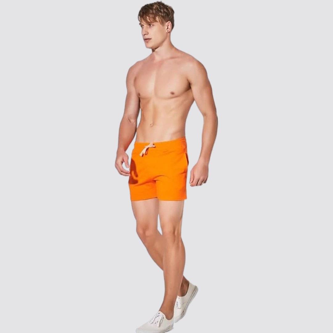 Side view of UrbanFit Basics Everyday Shorts in orange, designed for movement with breathable fabric and adjustable waist.