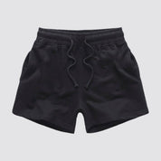 Flat lay of UrbanFit Basics Everyday Shorts in black with drawstring waist and side pockets, crafted for comfort and durability.